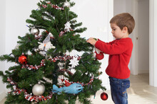 Chil Hanging Ornaments On Artificial Christmas Tree