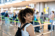 © Albert Martinez/Stocksy - Happy black woman waiting for flight