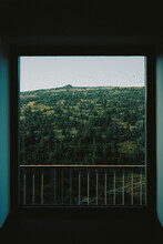 Green Mountain Landscape Through Window With Rain Drops