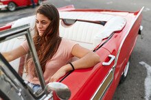Smiling Woman Driving A Vintage Car