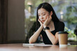 © Heng Yu/Stocksy - Young woman in a cafe reading an ebook