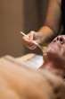 © Javier Pardina/Stocksy - Woman in mask on face in spa beauty salon