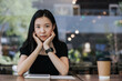 © Heng Yu/Stocksy - Young woman in a cafe with ebook