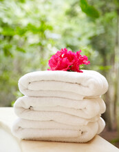 Folded Towels At Spa With Tropical Flower