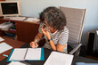 © Lightsy/Stocksy - Woman with grey hair taking notes and working