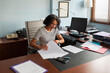 © Lightsy/Stocksy - Businesswoman reviewing files