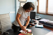 © Lightsy/Stocksy - Woman using a stapler in the office