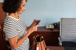 © Lightsy/Stocksy - Woman typing on her phone in the office