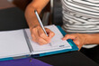 © Lightsy/Stocksy - Hands of a middle-age woman taking notes