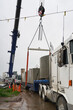 © Rowena Naylor/Stocksy - Crane removing load from truck