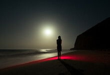 Dreamy Night Portrait Of Standing Woman At Empty Beach