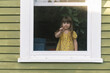 © Serena Burroughs/Stocksy - Funny portrait of toddler playing with window screen