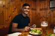 © Pedro Merino/Stocksy - Young man eating typical Viennese food in a restaurant