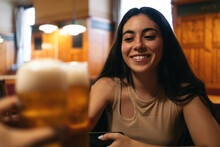 Young Woman Toasting With A Glass Of Beer