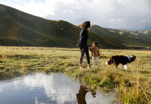 Asian Mother And Daughter Play In The Prairie Of Northwest China