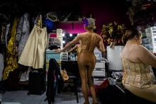 A Drag Queen Strikes A Pose In A Mirror Backstage
