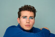 © Anastasia Antonova/Stocksy - Male Model Poses in Makeup Look