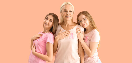 Poster - Beautiful women with pink ribbons on beige background. Breast cancer awareness concept