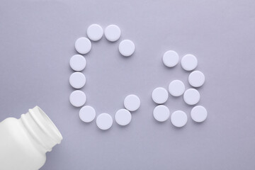 Open bottle and calcium symbol made of white pills on light grey background, flat lay