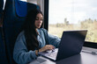 © Pedro Merino/Stocksy - Freelance woman working with laptop from the train