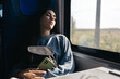 © Pedro Merino/Stocksy - Asleep young woman traveling by train