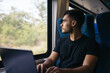© Pedro Merino/Stocksy - Young man working remotely with laptop on the train