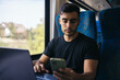 © Pedro Merino/Stocksy - Young man working with laptop and smartphone in the train