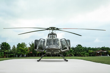 Wall Mural - Beautiful modern helicopter on helipad in field