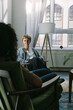 © VISUALSPECTRUM/Stocksy - White Female Counselor in Session With Anonymous Woman