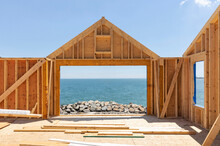 Residential Wood House Frame Under Construction Work By The Coast 