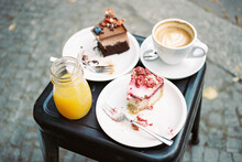 Cakes, Orange Juice , And Coffee At A Cafe