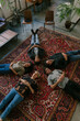 © VISUALSPECTRUM/Stocksy - Five People Lying on Carpet During Group Therapy