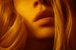 © Sonja Lekovic/Stocksy - sensual lips closeup in orange light
