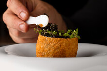 Crop Chef Decorating A Scotch Egg Recipe With Caviar