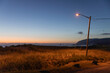 © Raymond Forbes LLC/Stocksy - Oregon Coast landscape single Streetlight at sunset