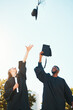 © Allistair F/peopleimages.com - University, graduation and students with graduation cap in air for celebration, happiness and joy. College, education and man and woman throw hats after achievement of degree, diploma and certificate