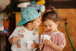 © Guille Faingold/Stocksy - Toddlers eating yogurt.