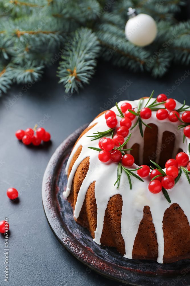 Delicious Christmas cake with cranberry on dark background, closeup