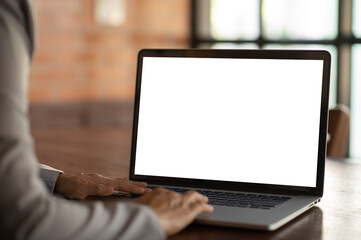 Wall Mural - women using laptop computer working at home with blank white desktop screen. with clipping paths.