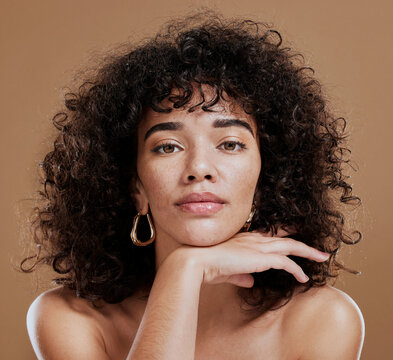 makeup, confident and portrait of a woman with hair care, skincare and beauty against a brown studio