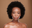 Black woman, beauty portrait and afro hair, skincare and facial treatment for shine, glow or healthy skin on studio background. African model, curly hair and aesthetic makeup, cosmetics and self care