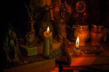 illustration of magical stuff....candle light, magic wand, book of spells dark background, wizarding