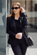 © andriyyavor - Outdoors lifestyle portrait of stunning brunette girl. Drinking coffee and walking on the city street.