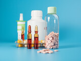 Fototapeta  - Various medicines on a blue background. Pills, spray, capsules and ampoules on a blue background.