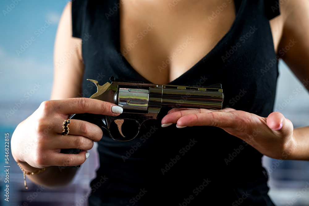 faceless woman in stylish dress holds revolver for shot against ...