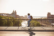 © FOLIO - Man riding bicycle on bridge
