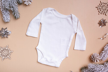 Wall Mural - Baby t-shirt mockup for logo, text or design on beige background with winter decorations top view