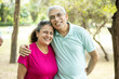 © GAJENDRRA BHATI  - Portrait of Happy indian senior couple at summer park. Mature Asian man and woman standing outdoor smiling. Old people india retirement life,