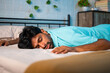 © WESTOCK - Tiered exhausted young man fallen on bed at bedroom - concept of fatigue, overworked and sleeplessness