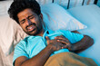 © WESTOCK - young Indian man got sudden chest pain while in deep sleep at night - concept of healthcare, illness and heart ache.